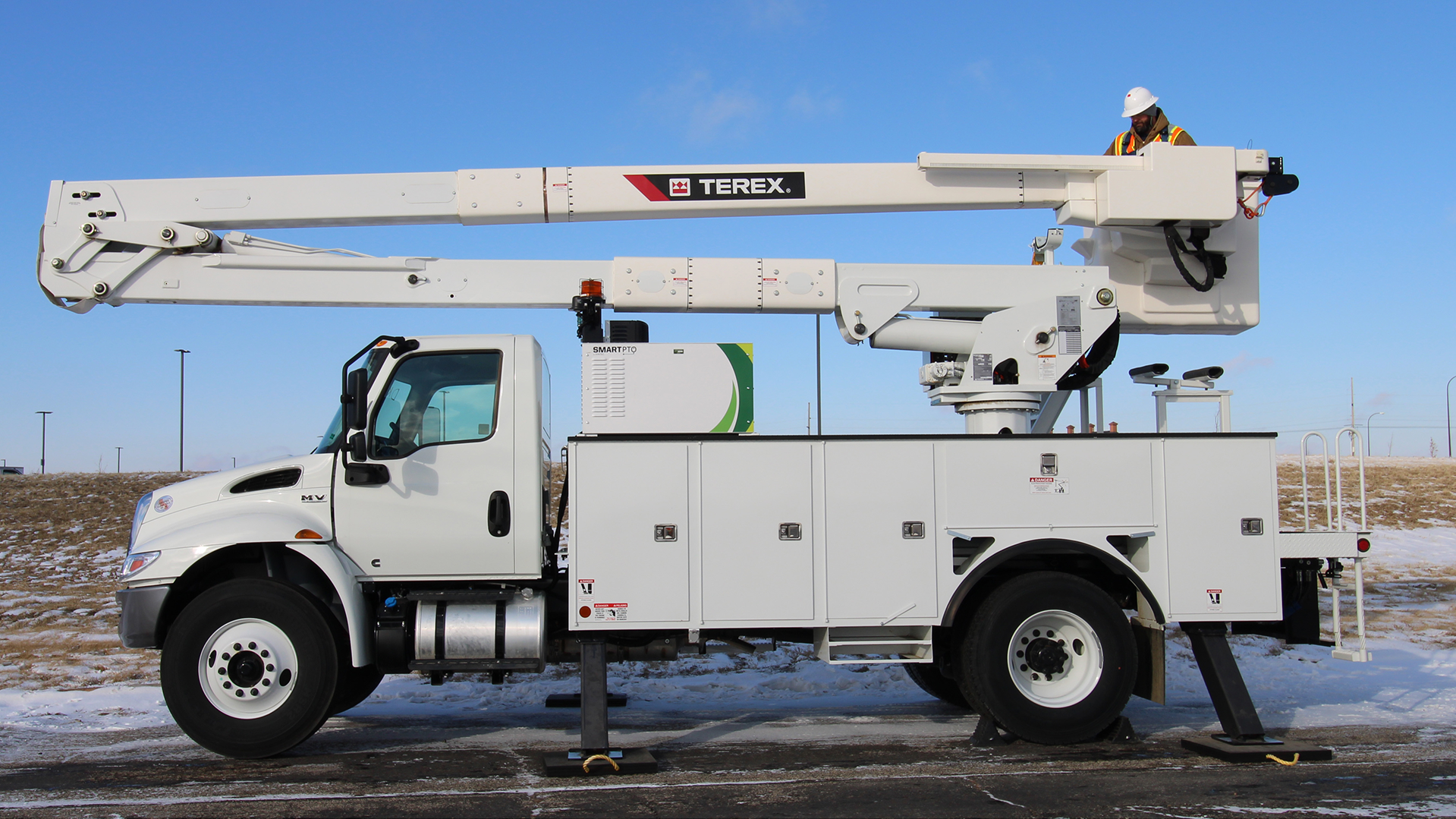 alt= Terex Hypower hybrid work truck outfitted with Viatec's SmartPTO backdropped with a blue sky