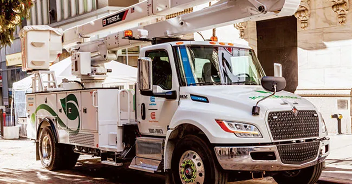 A white commercial utility work truck equipped with a Terex bucket lift parked on a city street, showcasing the green and white Viatec branding on the door.